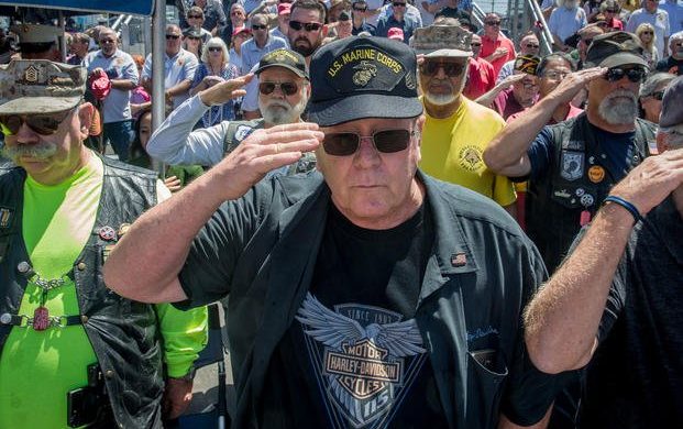 Saluting Veteran's Marching in a Parade.